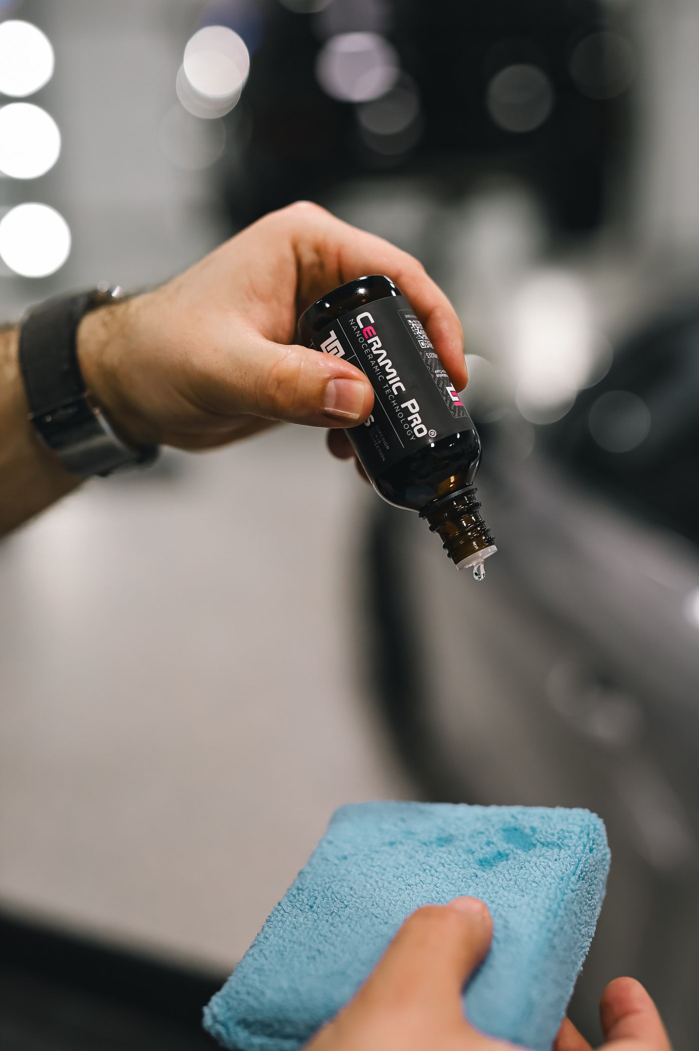 Ceramic coating liquid being dispensed onto a microfiber applicator
